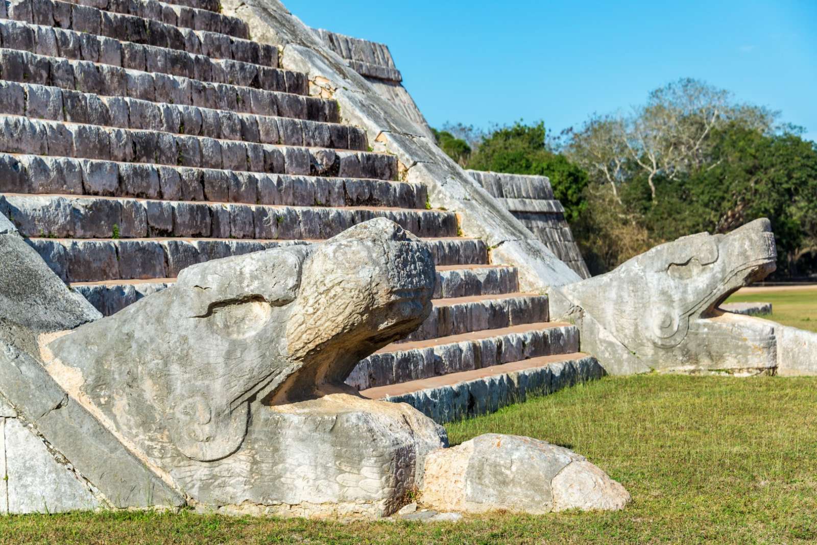 Snake heads at bottom of pyramid at Chichen Itza