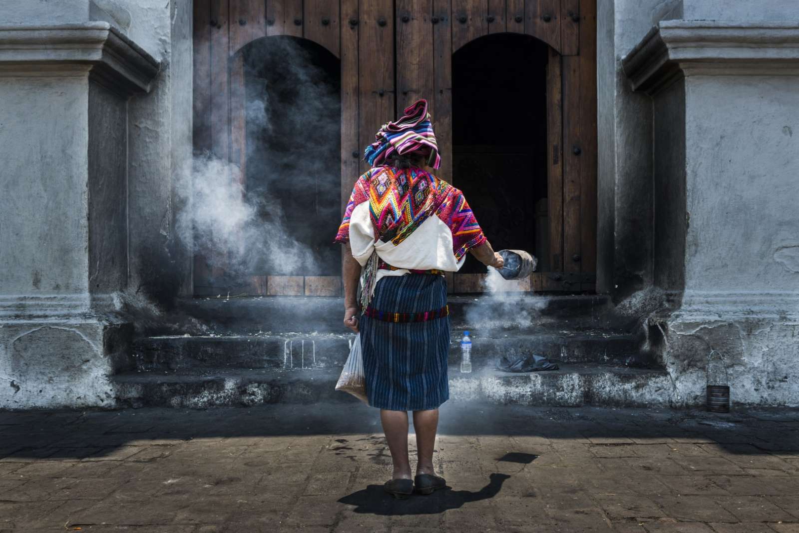 Mayan woman praying in front of Santo Tomas church at Chichicastenango, Guatemala