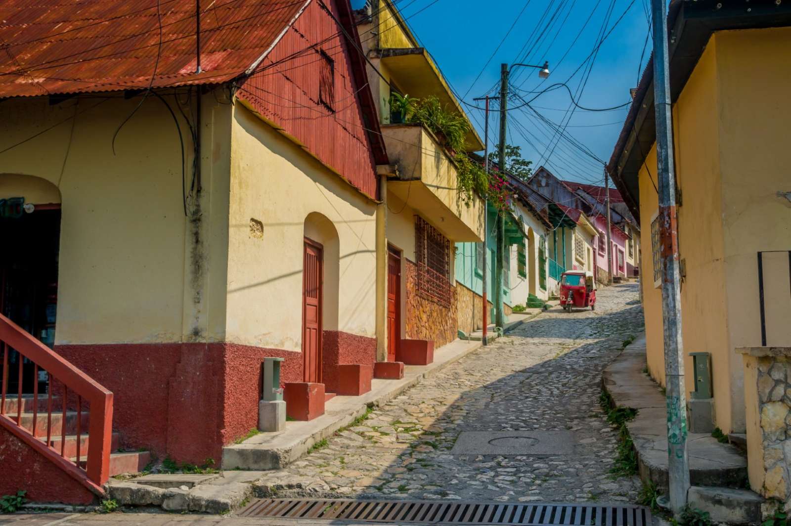 Quiet cobbled steet with rickshaw in Flores, Guatemala