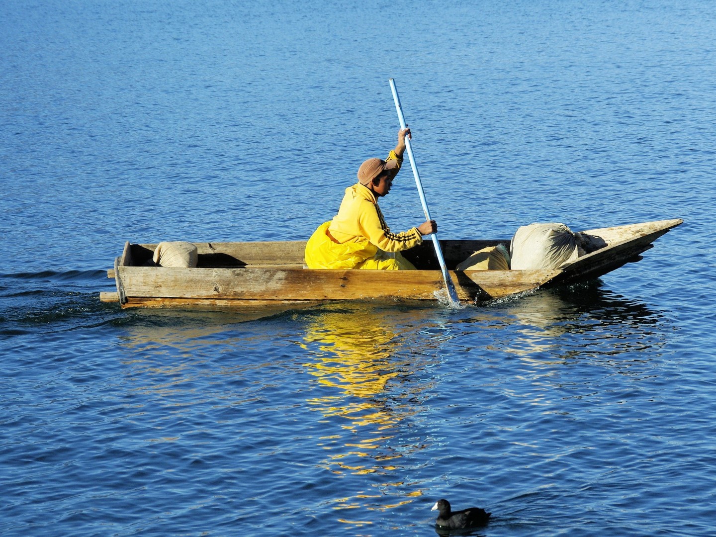 Man rowing small canoe on Lake Atitlan