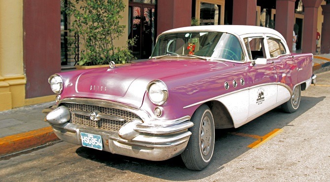 A old, purple classic car in Havana, Cuba