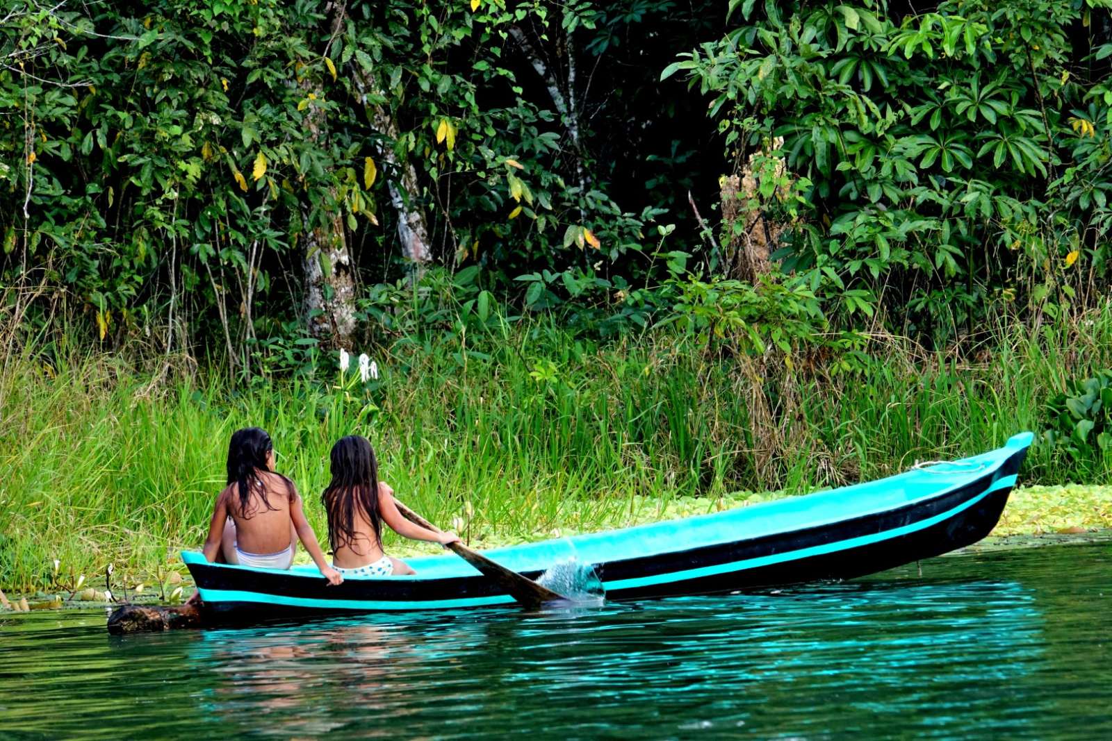Livingston & Rio Dulce Two young girls in canoe on Rio Dulce, Guatemala