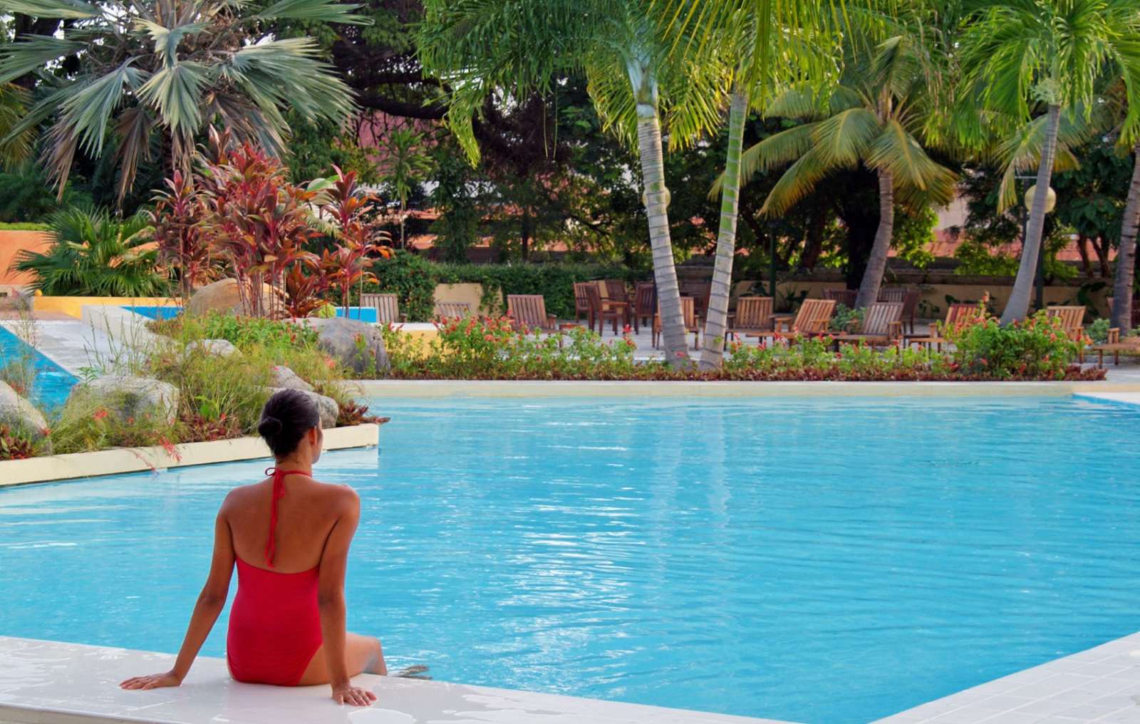 Woman sat facing pool at Melia Santiago