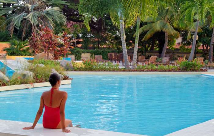 Woman sat facing pool at Melia Santiago