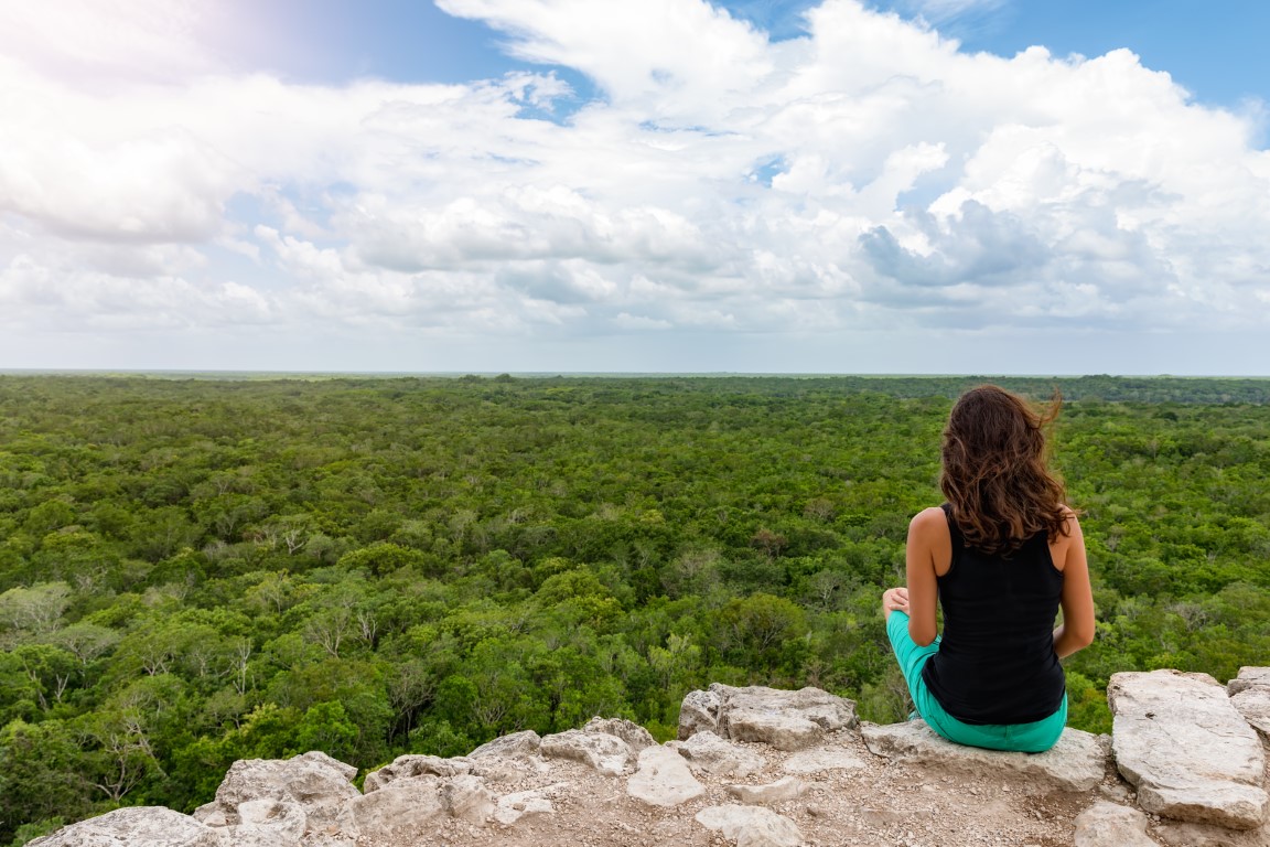 Woman on top of main pyramid at Coba