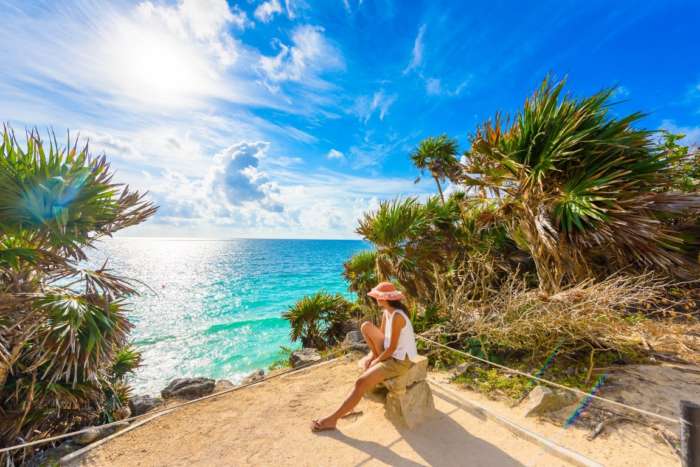 A woman looking out to sea at Tulum