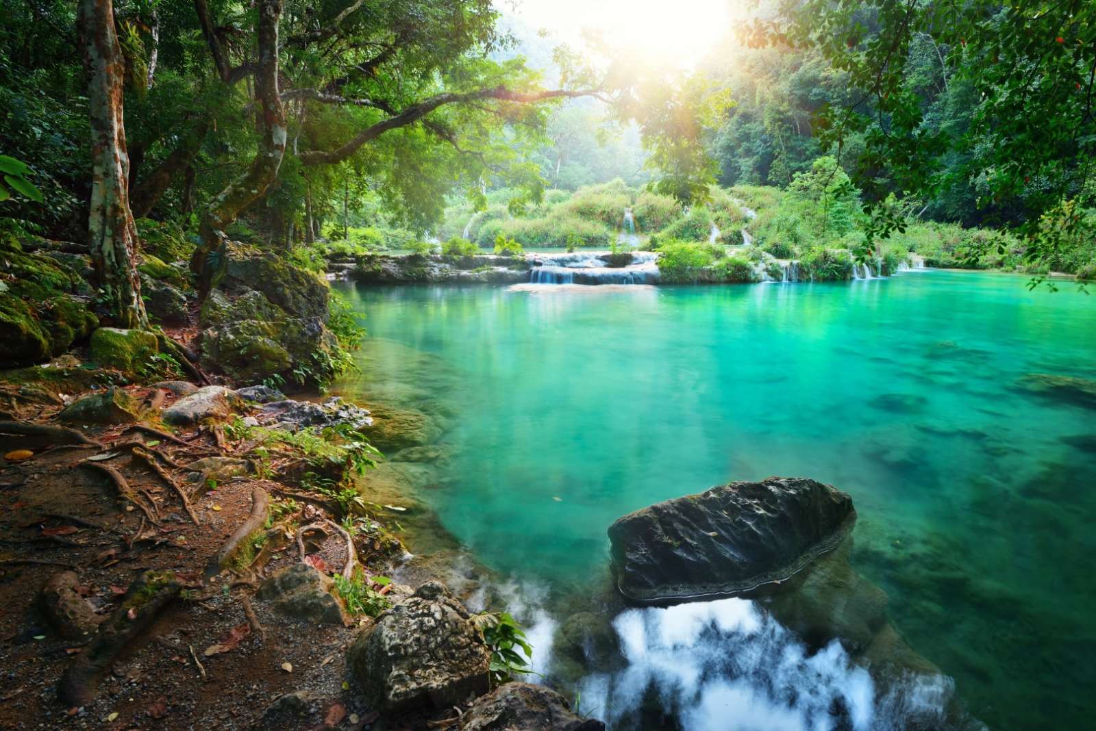 Clear pool at sunrise in Semuc Champey in Guatemala