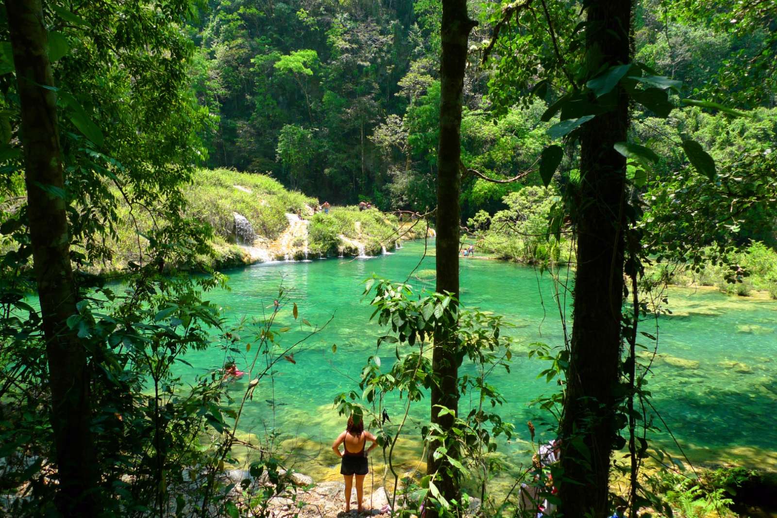 Woman looking at pool in Semuc Champey in Guatemala