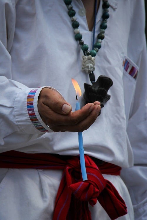 Guatemala priest holding candle