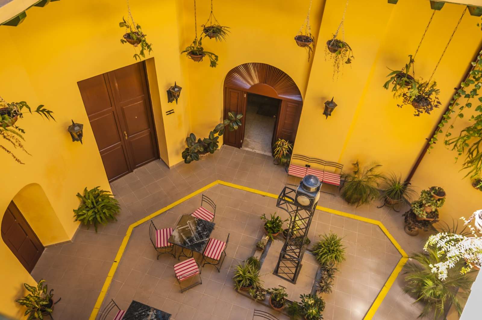 Bright yellow courtyard at Camino de Hierro