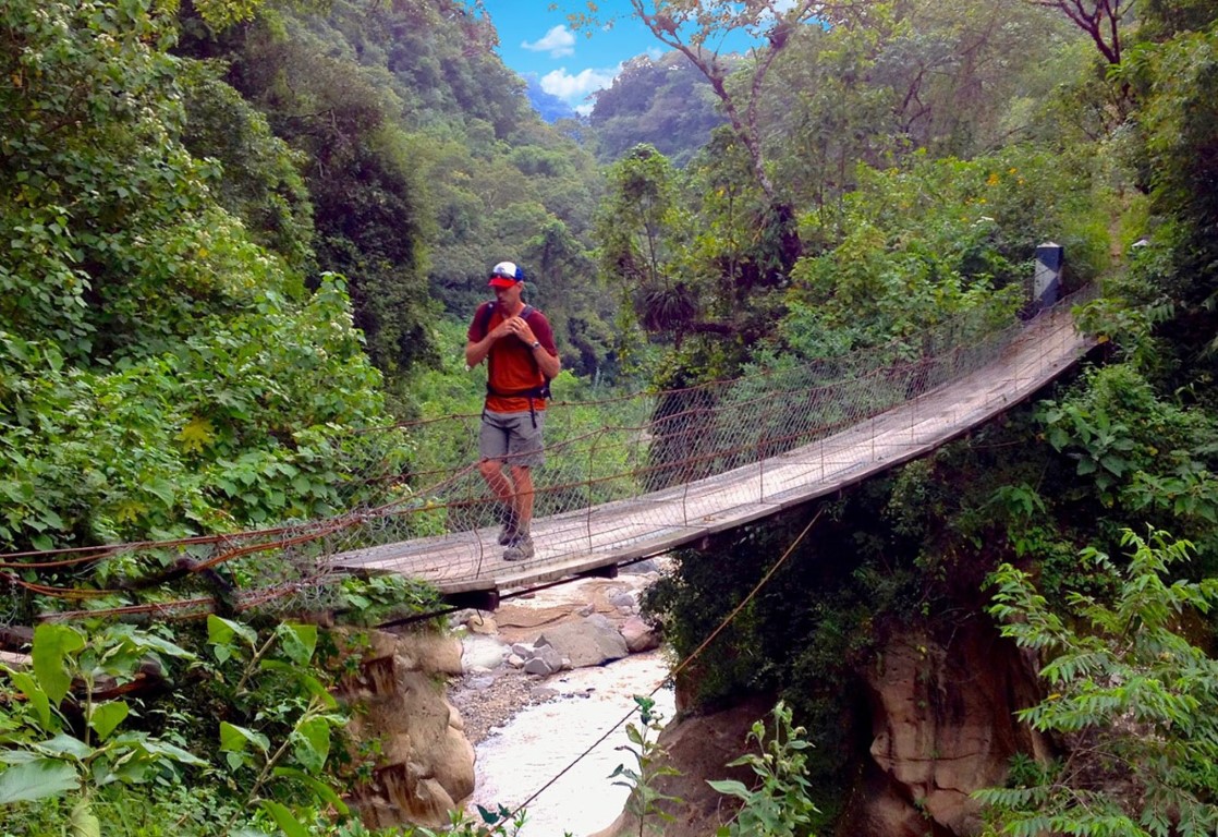 Crossing a hanging bridge while hiking in Guatemala