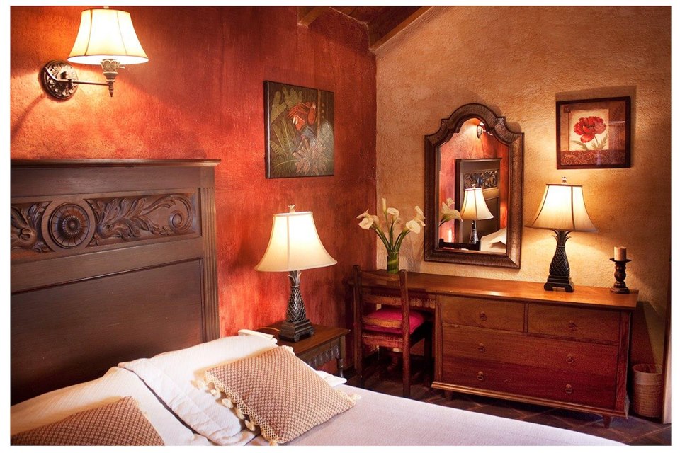 Bedroom with desk at Hotel Meson de Maria in Antigua