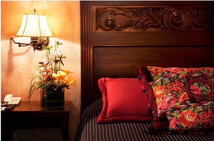 Cushions on bed at Hotel Meson de Maria in Antigua