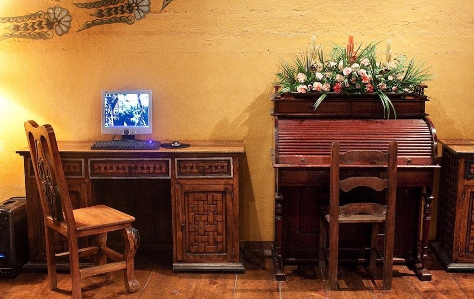 Two desks and a computer at Hotel Meson de Maria in Antigua