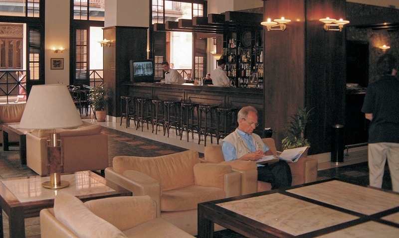 Man reading newspaper in hotel lobby