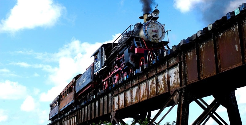 Steam train on a railway bridge in the Valley of the Sugar Mills