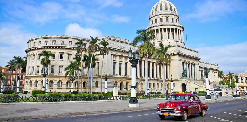 Car driving past the Capitol building in Havana