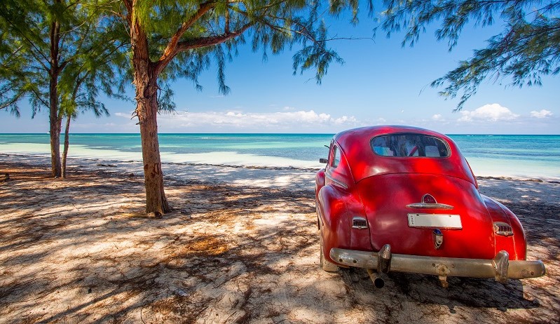 A vintage car on the beach in Cuba