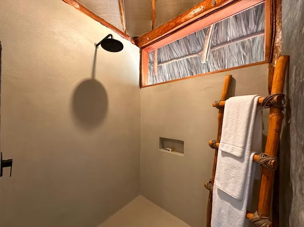 Hotel bathroom with smooth concrete walls and floor