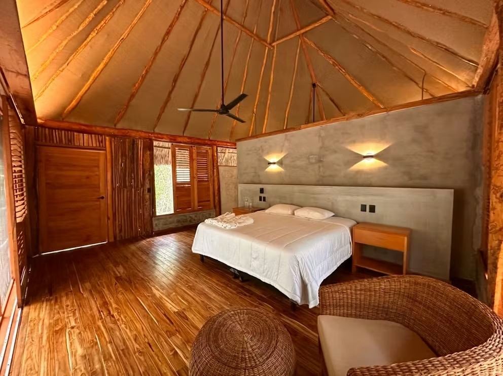Large hotel bedroom near Calakmul with king bed and wooden floor