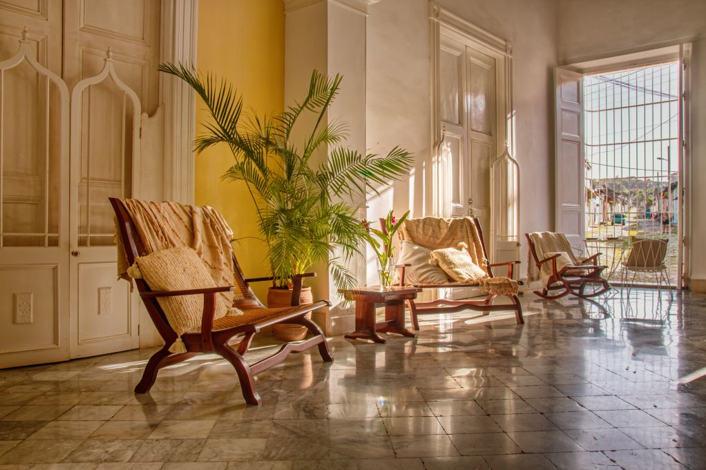 Hotel lobby in Trinidad, Cuba with planter chairs and tiled floor