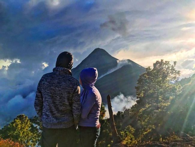 Couple overlooking a volcano in Guatemala